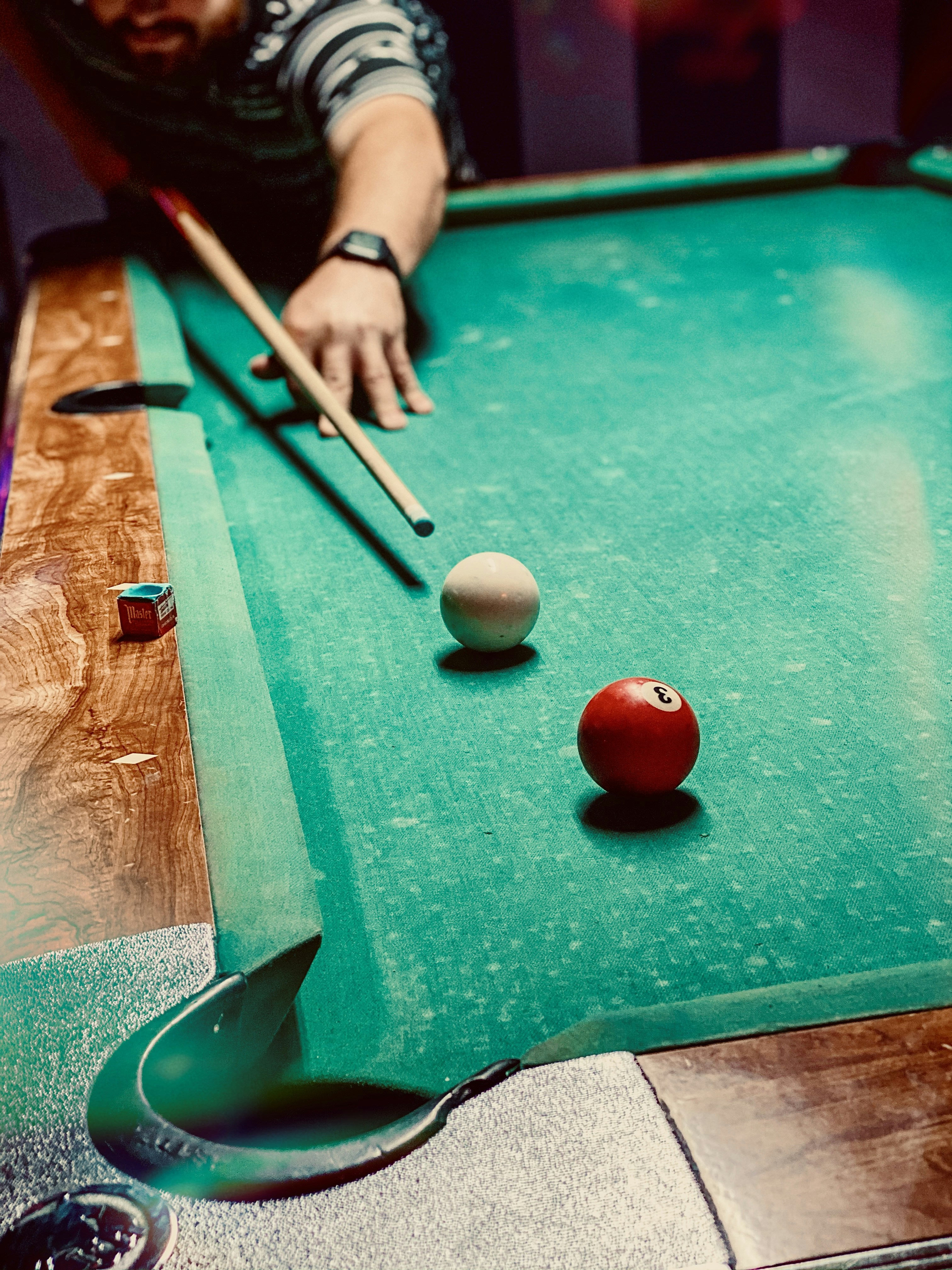 On the pool table.